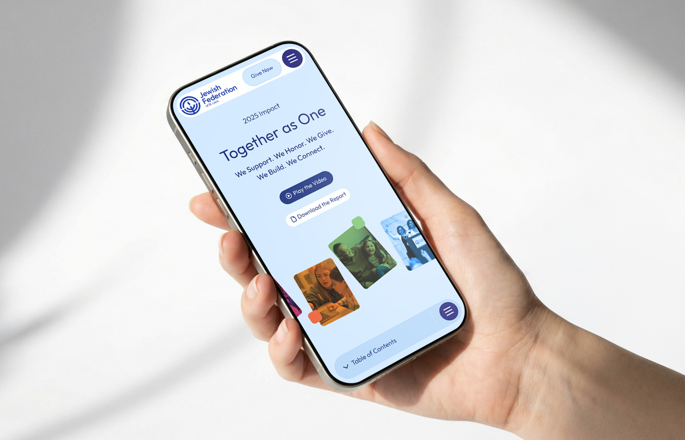 hand holding a mobile phone with the jewish federation of st. louis website showing